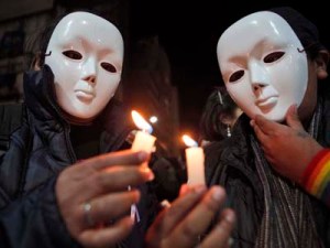 Seek the light: Activists wearing masks hold up candles during a demonstration marking International Day Against Homophobia in La Paz, Bolivia, on May 17. According to LGBT leaders, 24 people from the LGBT community have been murdered in the last 18 months in Honduras because of their sexual orientation. AP/Juan Karita