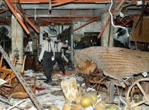 Searching for clues: Police inspect one of the restaurants that suffered the worst impact of the 2002 Bali bombings in Kuta. JP