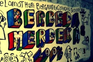 Debutant: Radio announcer Nastasha Abigail’s version of Sunday 13th Street Art Movement’s slogan stands out in block letters on a wall at Jl. Cinere Raya in Jakarta. The Feb. 13 movement gave Abigail the momentum to paint a mural in public space for the first time.