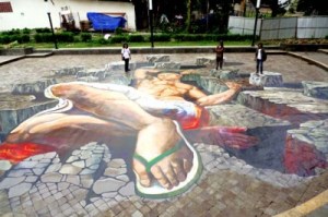 Larger than life: Members of Lintas Melawai stand on the 3D illusionist painting titled In Maridjan We Trust.