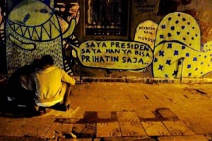 Debutant: Radio announcer Nastasha Abigail’s version of Sunday 13th Street Art Movement’s slogan stands out in block letters on a wall at Jl. Cinere Raya in Jakarta. The Feb. 13 movement gave Abigail the momentum to paint a mural in public space for the first time.