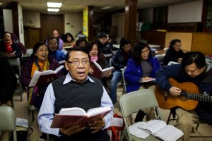 A prayer meeting at Grace Indonesia Baptist Church in Woodside, Queens. Credit Katie Orlinsky for The New York Times